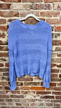 periwinkle blue open-knit long-sleeve sweater with a round neckline on a hanger