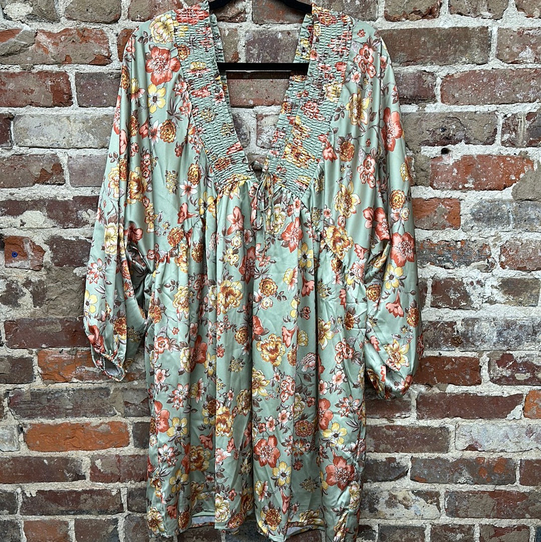 sage floral long-sleeve dress with a smocked v-neck border and front ties on a hanger