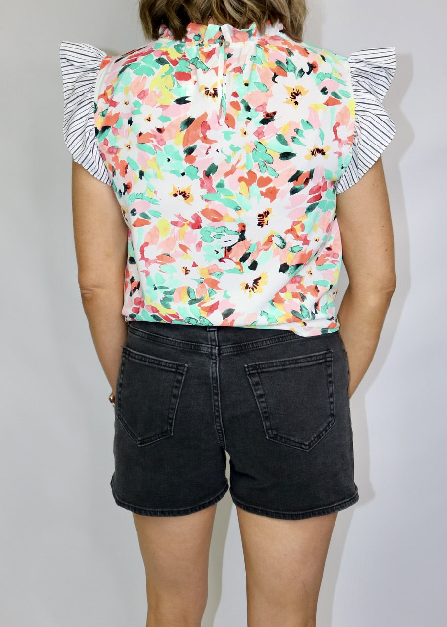 back view of washed black denim shorts showing two patch pockets and finished hems