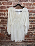 front view of an ivory pleated long-sleeve dress with a v-neck and raised waist seam